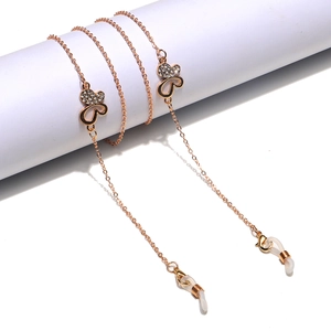 Rose gold butterfly eyewear chain with sparkling rhinestones on a white display