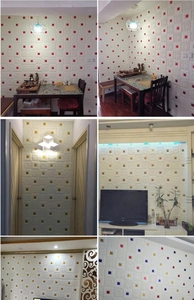 Detail showing 3D embossed foam wall stickers with colorful square accents in home settings