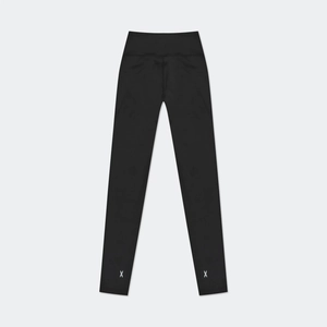 Detail of black high-elastic leggings showing symmetrical white X logo on the ankles