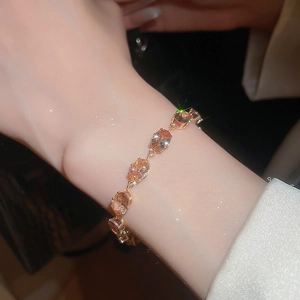 Detailed view of the champagne oval zircon stones set on a dainty gold plating chain