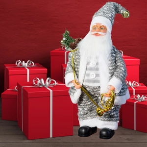 Detailed view of Santa figurine in grey jacket with golden horn and festive pine decor