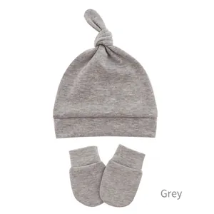 Detailed view of grey knotted baby beanie and scratch mittens set in soft cotton knit