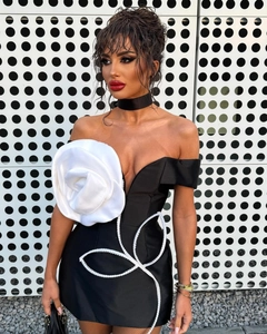 Détail d'une robe bustier noire avec une rose en soie 3D et des accents de paillettes
