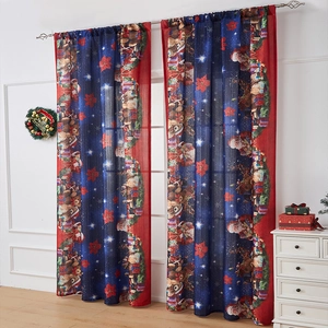 Detail of Christmas themed dark blue curtains featuring Santa Claus and reindeer prints