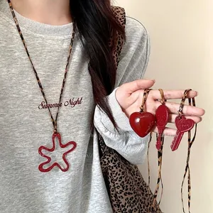 Red heart and key pendants on leopard print woven necklace for women casual wear
