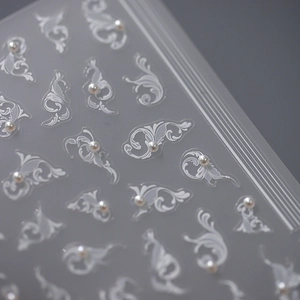 Elegant 5D white baroque scroll nail art stickers with delicate pearl accents for DIY manicure