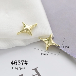 Macro shot of 19x14mm gold star charm connector for DIY jewelry on white silk