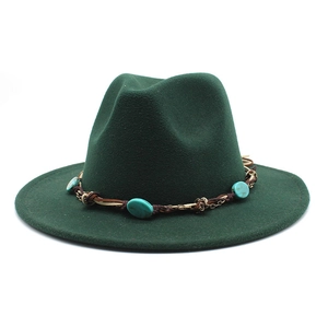 Detail of emerald green wool fedora hat featuring turquoise beads and braided leather band
