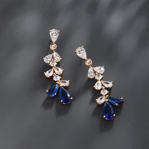 Detail of rose gold drop earrings with blue and clear pear-cut cubic zirconia crystals
