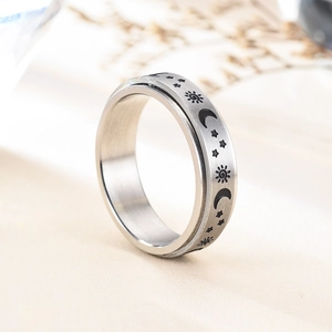 Rotating stainless steel moon and star fidget ring with a brushed silver metallic finish