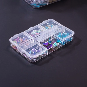 Detailed view of a 6-compartment clear organizer box filled with colorful nail art butterflies