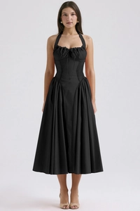 Close-up of black halter dress featuring ruched drawstring bust and woven texture detail