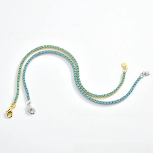 Close-up of vintage turquoise bead necklaces with claw chains in gold and silver finish