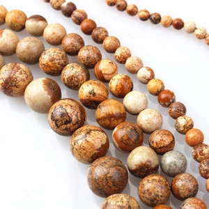 Macro shot of natural brown and beige landscape stone round beads for DIY jewelry making