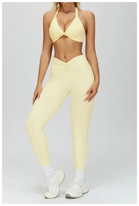 Detail of light yellow yoga set showing halter sports bra and V-waist leggings
