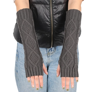 Detailed texture of dark grey knit fingerless arm warmers with diamond cable pattern