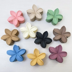 Detailed top view of 10 matte floral hair claws in various vibrant summer colors
