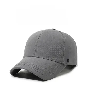 Detailed close-up of dark grey baseball cap showing twill fabric and metal JW logo