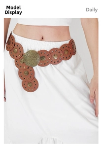 Detail of vintage bohemian waist belt with gold hammered metal discs and brown leather