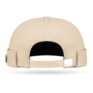 Beige brimless dockers cap with maple leaf metal badge and adjustable strap