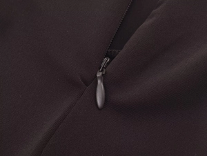 Detail of high-quality invisible zipper closure on a black knit halter neck dress