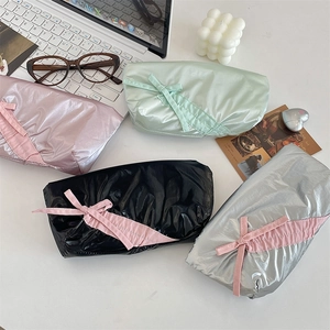Cute high-capacity bow pencil cases in four pastel colors on a stylish office desk