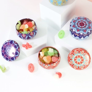 Mandala patterned 2.2oz tinplate storage containers for tea and candy on white stands