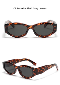 Detail view of tortoiseshell cat-eye sunglasses with dark grey lenses and polygon frames