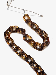 Close-up of retro leopard print acrylic eyeglass chain with glossy tortoise links