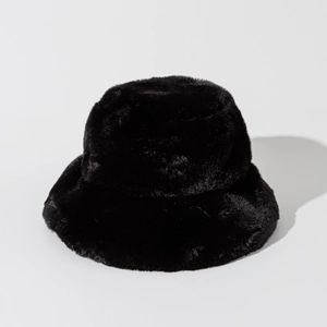 Detail of premium black faux fur texture on a thick winter bucket hat for warmth