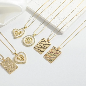 Macro detail of gold necklaces with MOM pendant and mother-child design for Mother's Day
