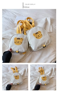 Detail of child's canvas backpack featuring yellow cartoon tiger patch and adjustable straps