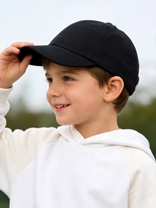 Side view of children's black cotton baseball cap with curved brim and breathable eyelets