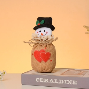 Detailed view of burlap Christmas candy bag with snowman head and red heart patch
