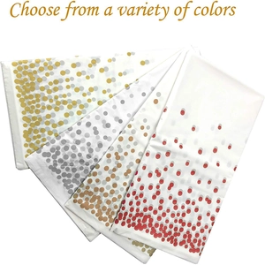Detail of disposable paper tableware featuring gold and rose gold metallic foil polka dots