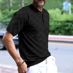 Detail of black men's Polo shirt featuring textured checkered jacquard knit fabric