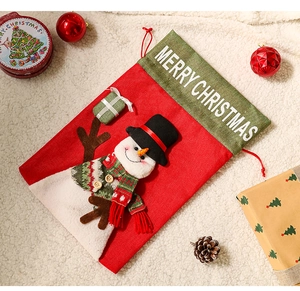 Close-up of a festive burlap Christmas stocking with a snowman and Merry Christmas text