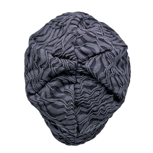 Macro detail of dark grey double-layered pleated fabric on a stylish beanies hat