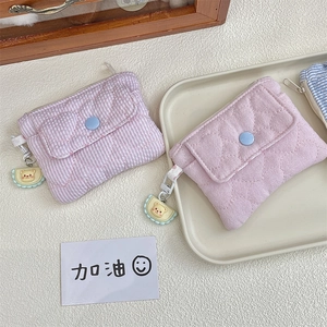 Detail of mini quilted coin purses with snap buttons and cute bear keychain charm