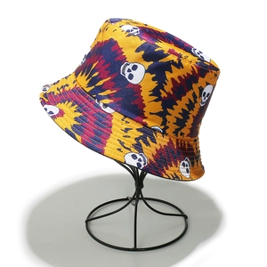 Detail of tie-dye fisherman hat featuring skull prints in yellow, purple and red tones