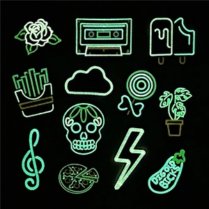Luminous glow-in-the-dark embroidery patch set with various icons on black background