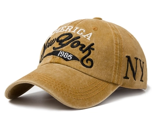 Detail of vintage yellow washed cotton baseball cap with intricate New York embroidery