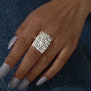 Close-up of a wide square silver ring with shimmering micro-pave crystals on denim