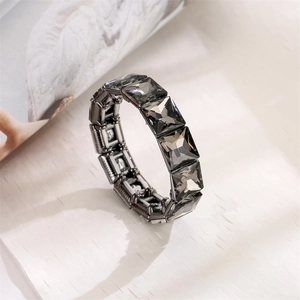 Detailed view of square cut smoky gray crystal beads with gunmetal alloy stretch band