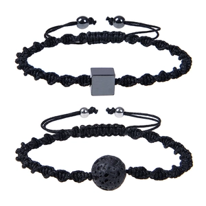 Detail of adjustable woven couple bracelets featuring volcanic stone and square mineral bead