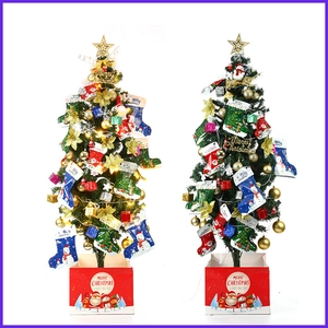 Mini lighted Christmas tree with ornaments and stockings on white background
