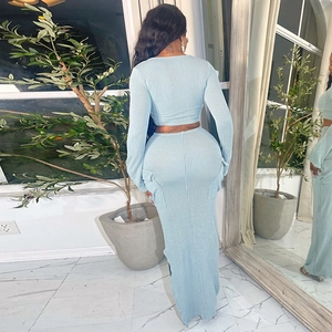 Detail of light blue ribbed knit texture on long sleeve crop top and matching skirt