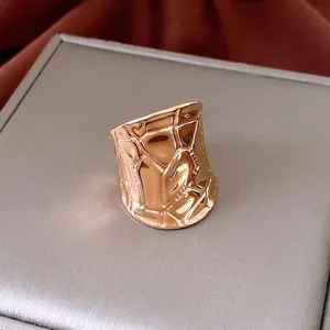 Rose gold geometric wide open ring with irregular rock texture and modern metallic finish
