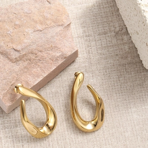 Golden irregular twisted hoop earrings in minimalist stainless steel for women