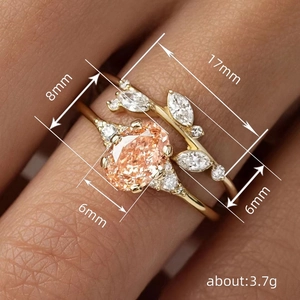 Elegant gold-tone ring set featuring leaf patterns and champagne oval zircon gemstone